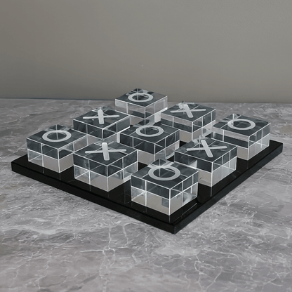 Transparent tic-tac-toe board with Xs and Os on a gray surface