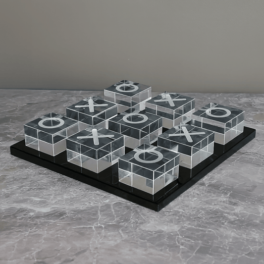 Transparent tic-tac-toe board with Xs and Os on a gray surface