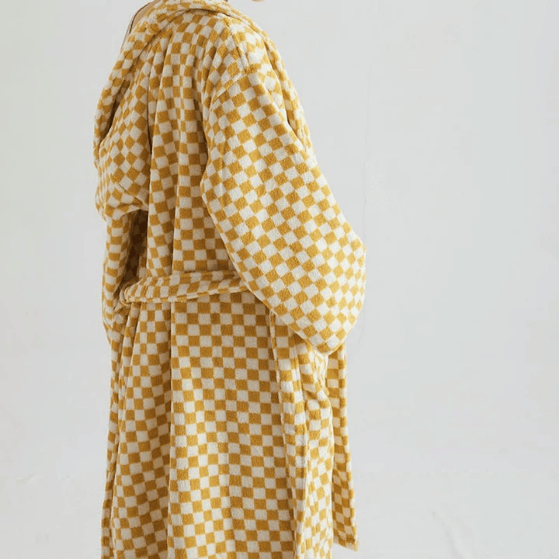 Yellow and white checkered dress on a plain background