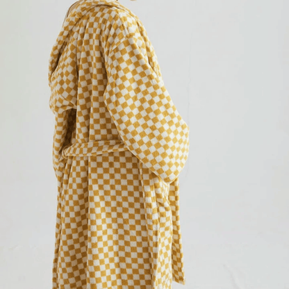 Yellow and white checkered dress on a plain background