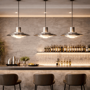 Modern bar setting with pendant lights, shelves of bottles, and chairs.