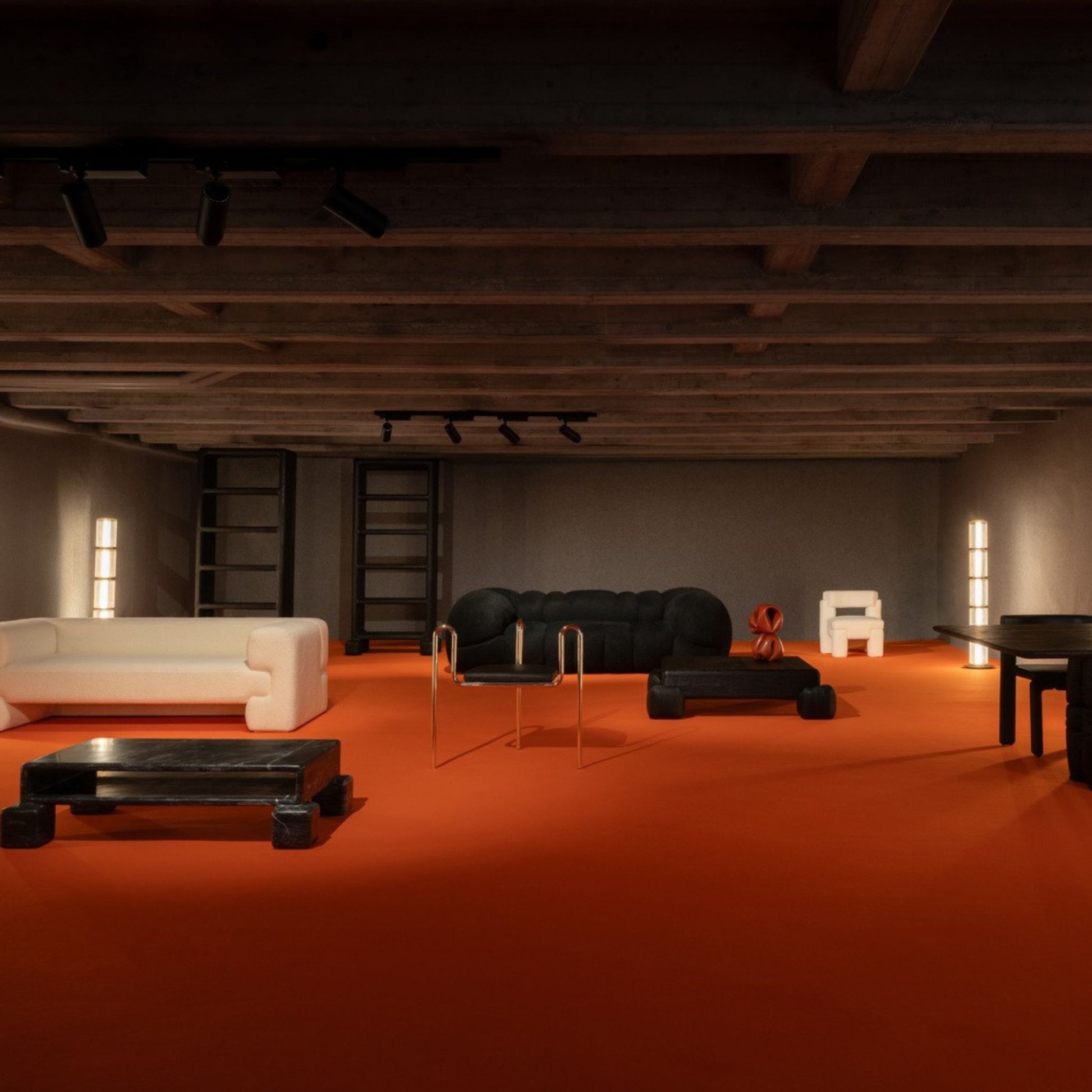 Tall glowing floor lamp standing on an orange carpet in a spacious interior.