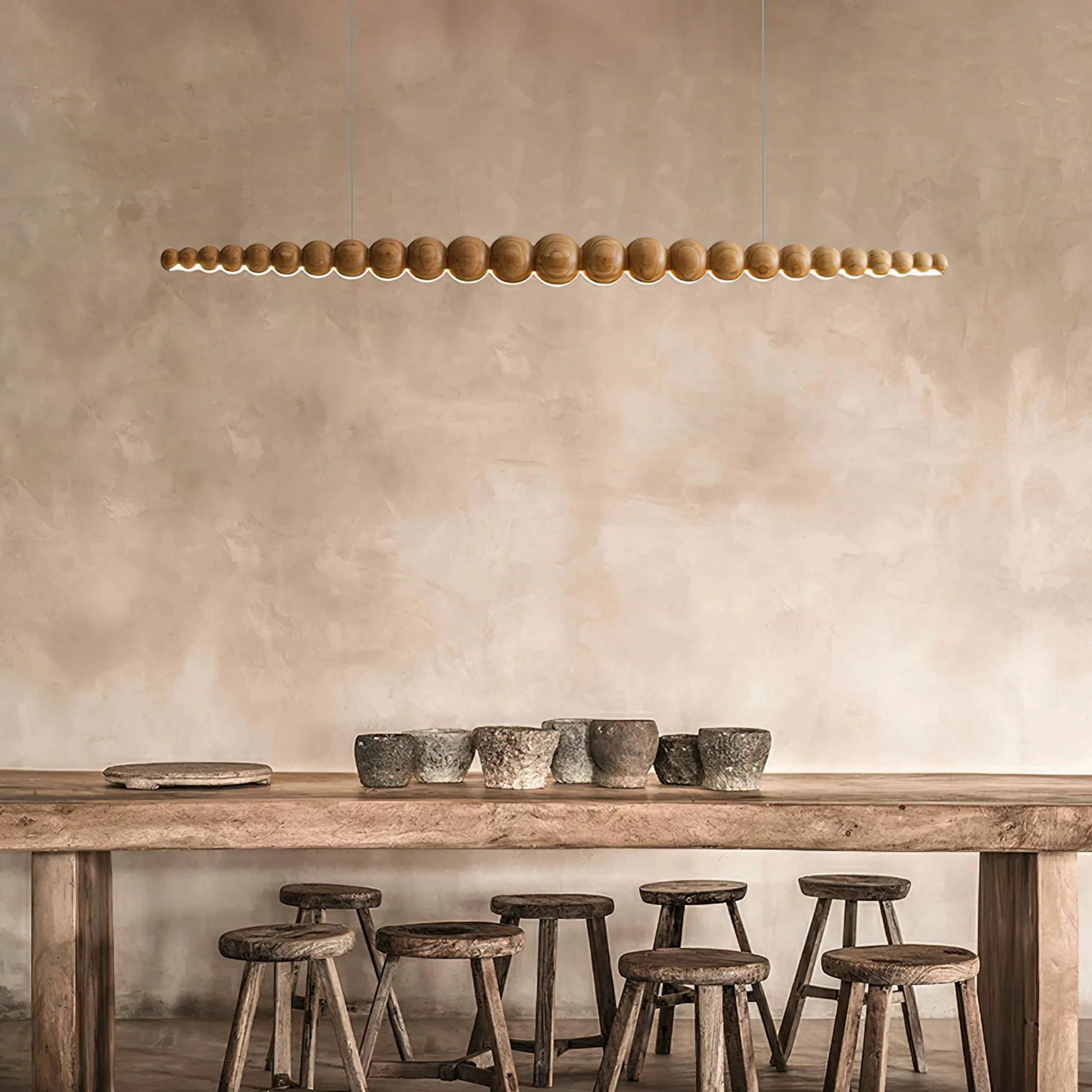 A modern kitchen with linear pendant lights hanging above a countertop, offering an elegant and functional light source.