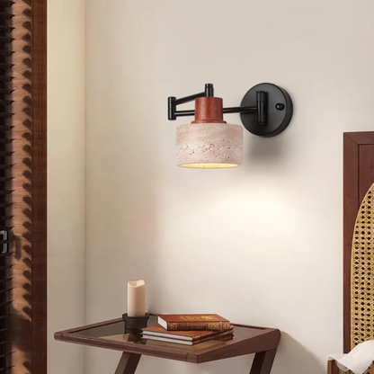 Wall-mounted lamp lighting up a small desk setup in a bedroom, adding a rustic yet modern touch.