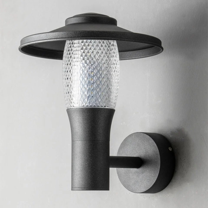 Contemporary black and glass wall lamp with textured diffuser mounted on exterior wall