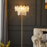 A modern and sleek living room corner with a floor lamp next to a plush armchair, offering a relaxing atmosphere.