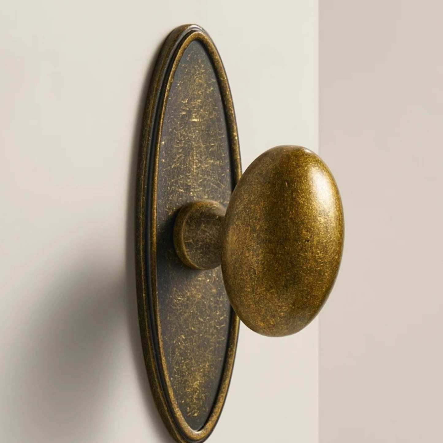 Close-up of an antique brass door knob highlighting its engraved detailing and classic finish.