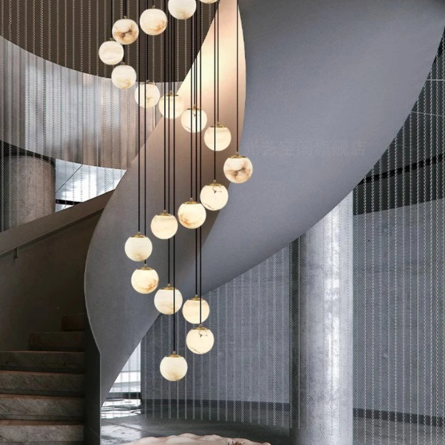 A top-down view of a spiral staircase with circular pendant lights suspended through the center.