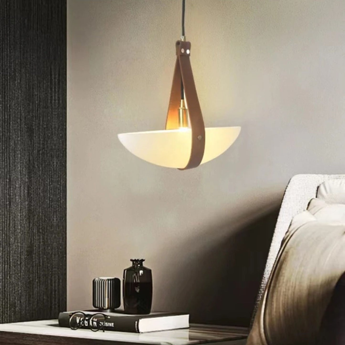 A close-up of a wooden cone pendant lamp with a warm illuminated dish-like shade in a modern room.