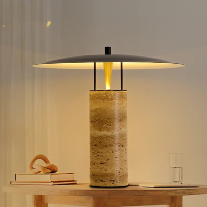 Designer stone and metal LED table lamp creating soft, cozy illumination for interior spaces.