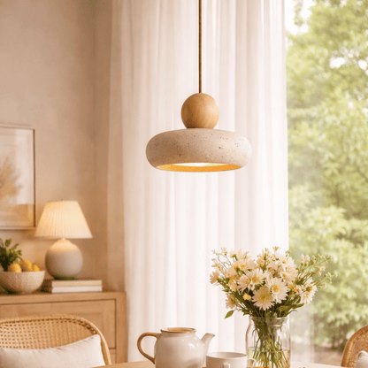 Pendant light fixture in a room with a window, flowers, and a teapot.
