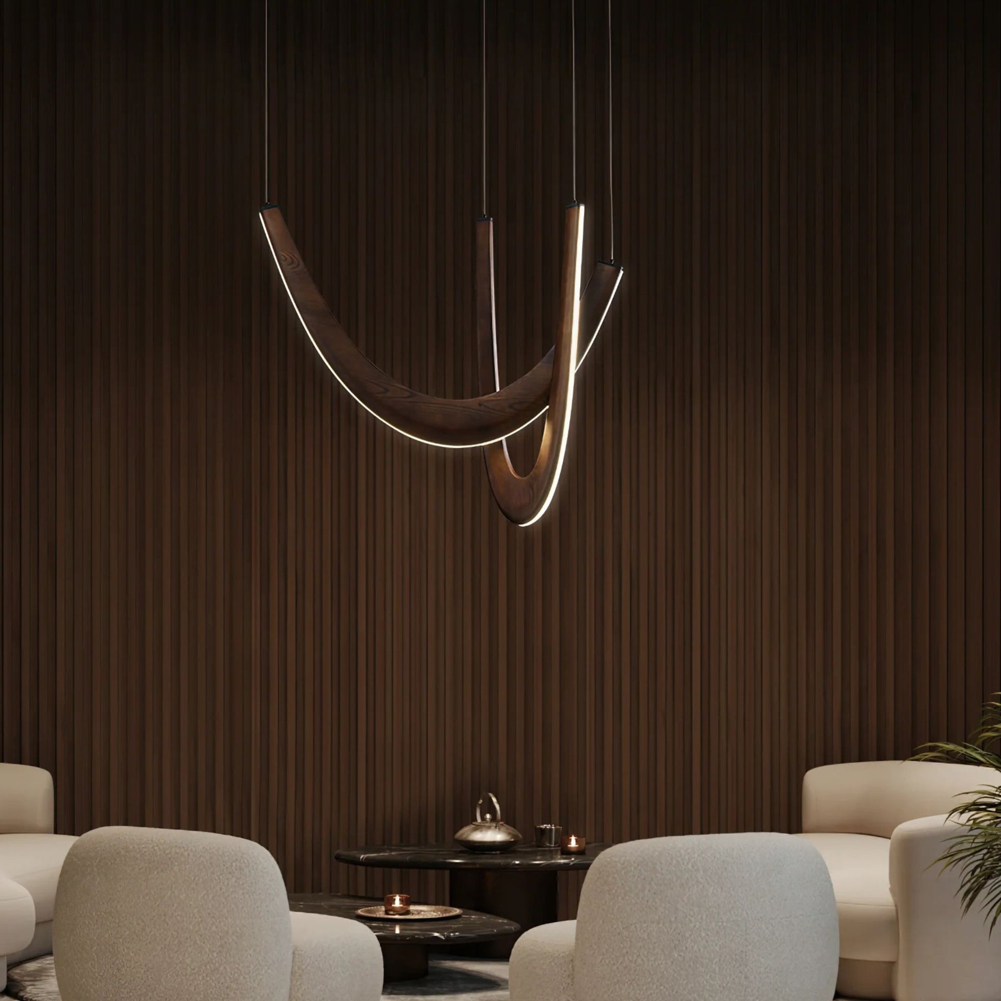 A close-up of a modern pendant light with wooden arcs and glowing bulbs, illuminating a dining area.
