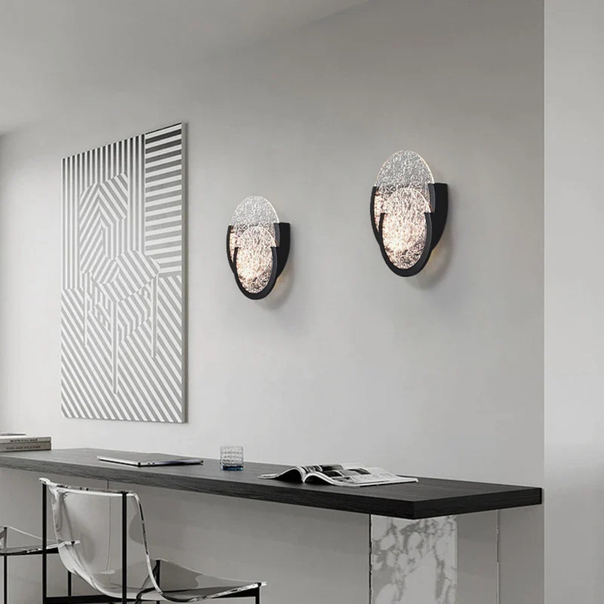 Contemporary hallway with a circular double-glass wall lamp creating a diffused decorative light.