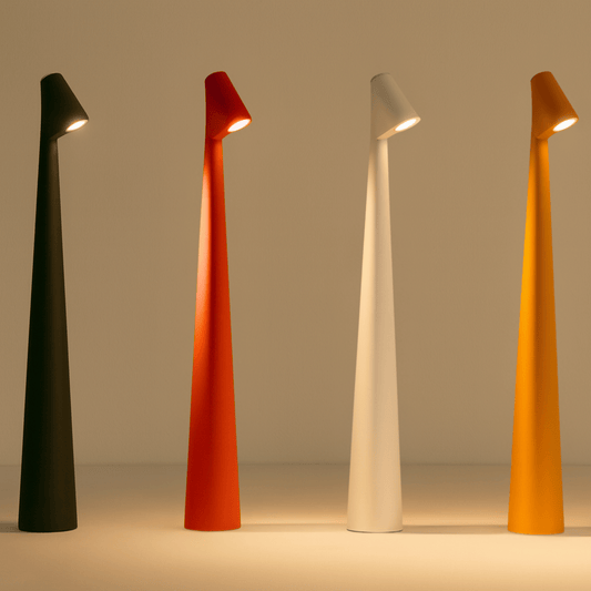 Four modern floor lamps in black, red, white, and orange on a beige background.