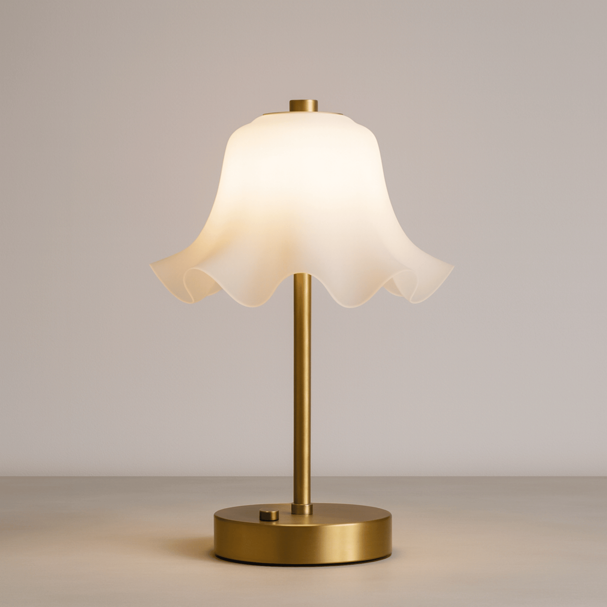 Table lamp with a white shade and gold base on a neutral background