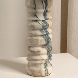 Marble column with gray and beige patterns on a neutral background