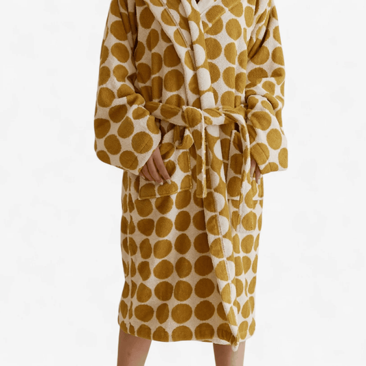 Yellow and white polka dot robe on a white background