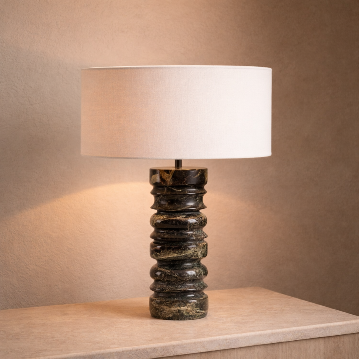 Table lamp with a textured black base and white shade on a wooden surface.