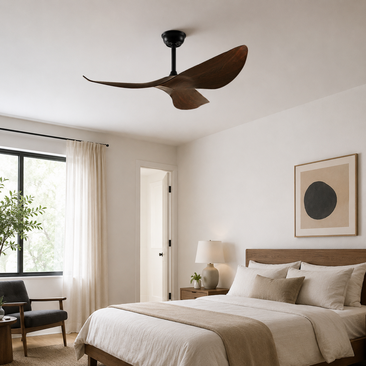 Modern bedroom with a ceiling fan, bed, and decor elements.