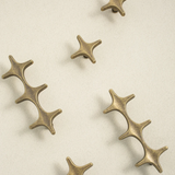 Bronze star-shaped decorative elements on a beige background