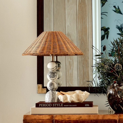 The lamp beside a bed in a minimalist bedroom setup, adding a soft decorative touch.