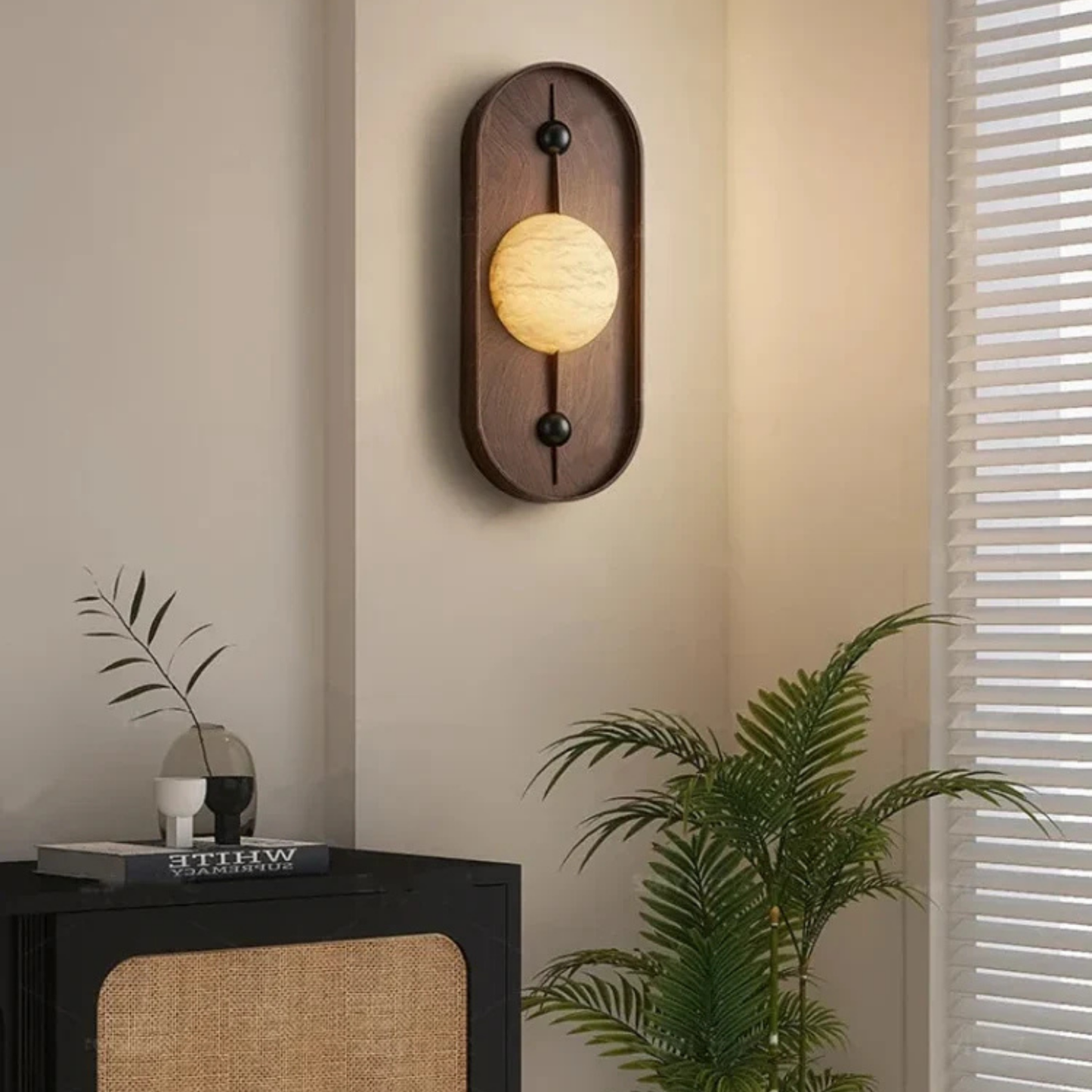 Wooden wall sconce with marble globe light placed in a stylish bedroom setup.