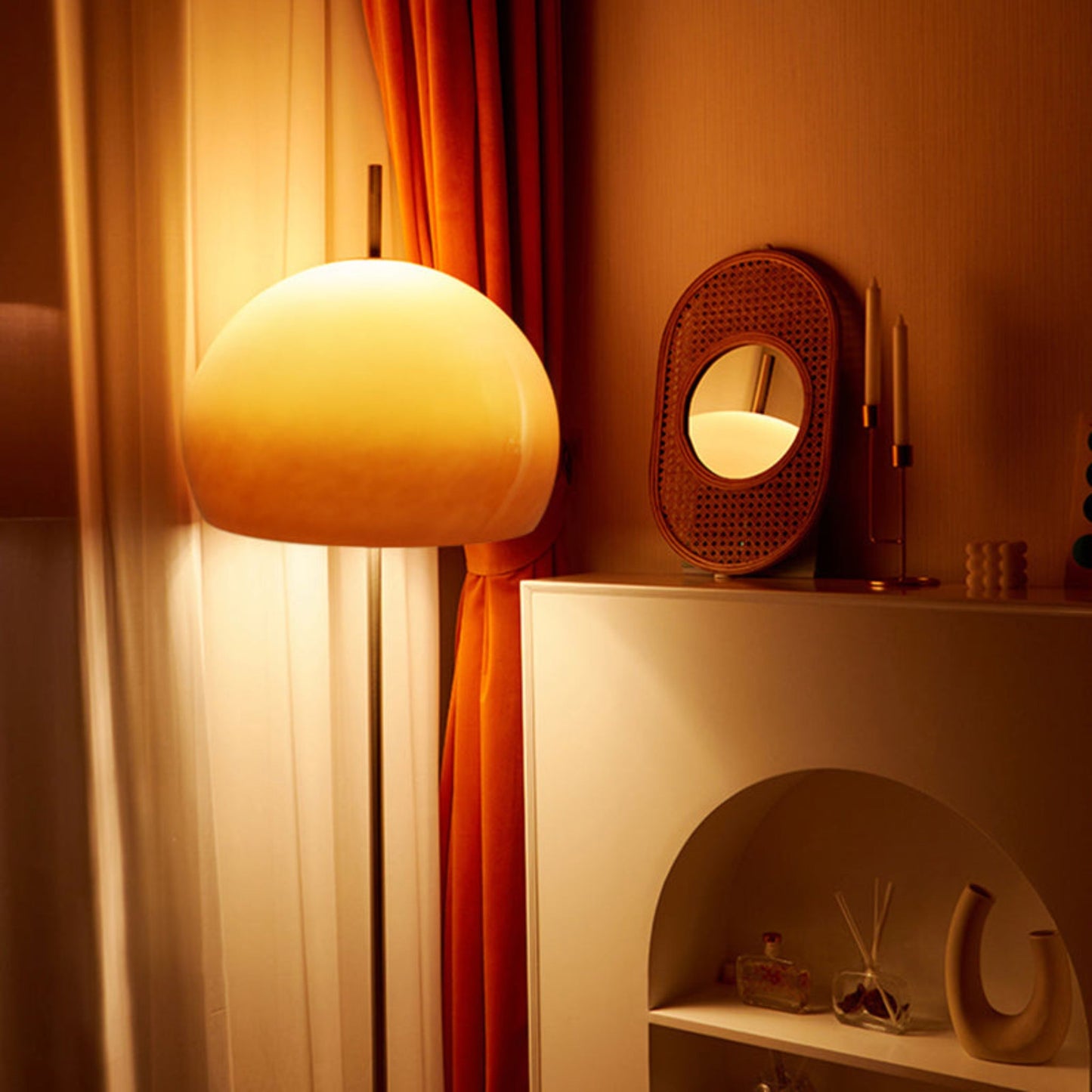 A sleek yellow globe-shaped floor lamp casting a warm glow in a room with white walls and a modern chair.