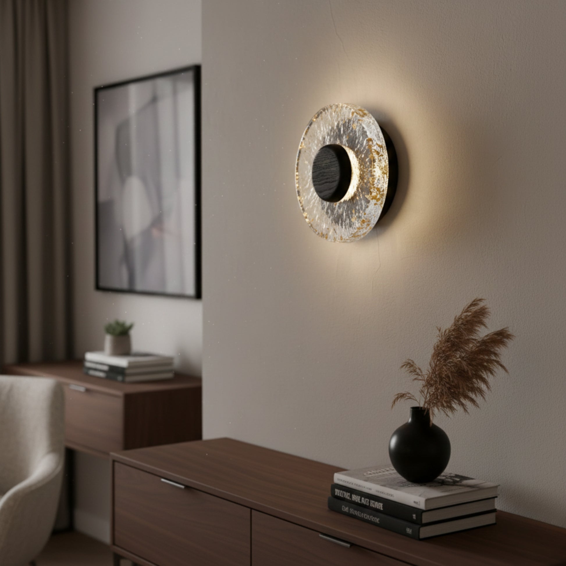 A decorative circular wall light with a textured outer ring and warm backlighting, mounted above a wooden sideboard in a contemporary interior.