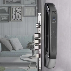 The smart door lock installed on a grey door in a contemporary living room setting.