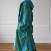 Blue and green striped robe draped over a chair against a white paneled wall.