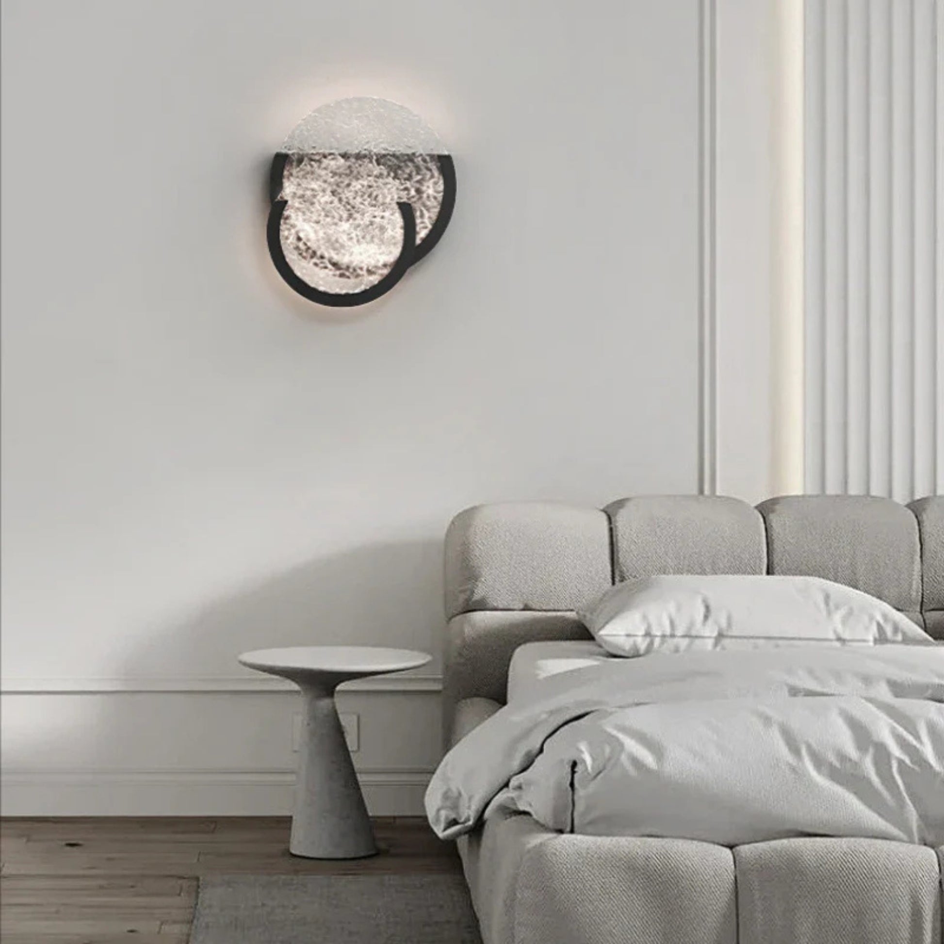 Bedroom wall light with overlapping textured glass circles, adding a soft ambient glow to the room.
