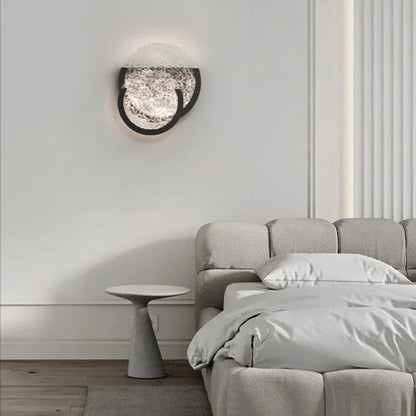Bedroom wall light with overlapping textured glass circles, adding a soft ambient glow to the room.