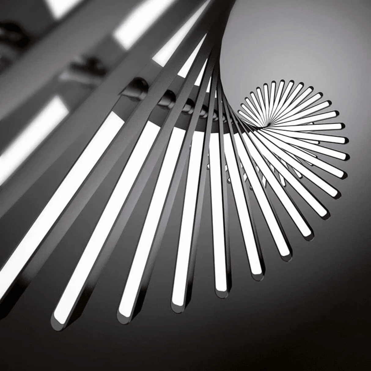 Close-up of a modern ceiling light fixture with geometric design on a dark background