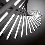 Close-up of a modern ceiling light fixture with geometric design on a dark background