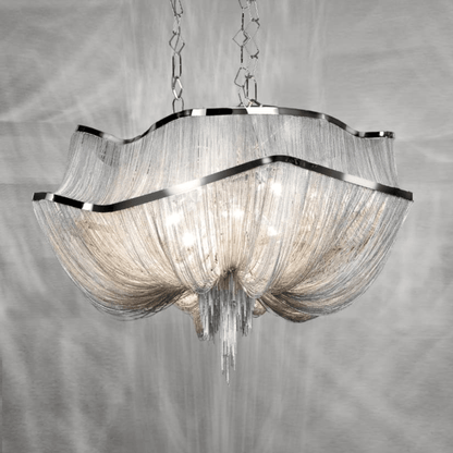Chandelier with glass shades and metallic frame on a gray background