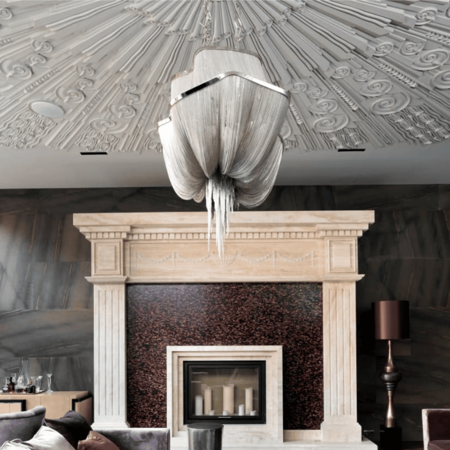 Decorative chandelier hanging above a fireplace in a stylish room with patterned ceiling.
