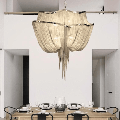 Chandelier hanging above a dining table in a modern interior setting.