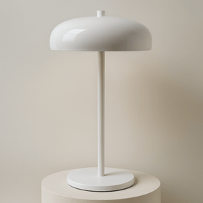 White table lamp on a stand with a beige backround