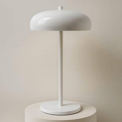White table lamp on a stand with a beige backround