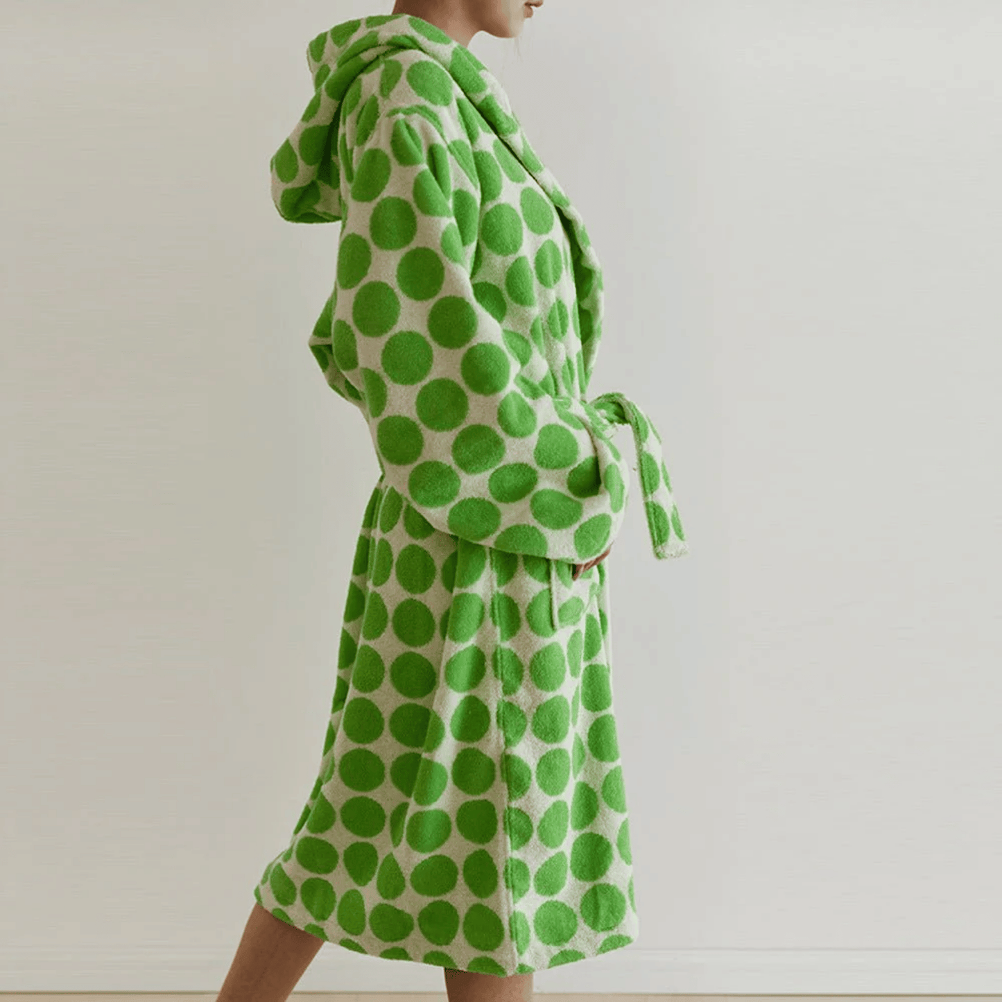 Green polka dot robe on a plain background
