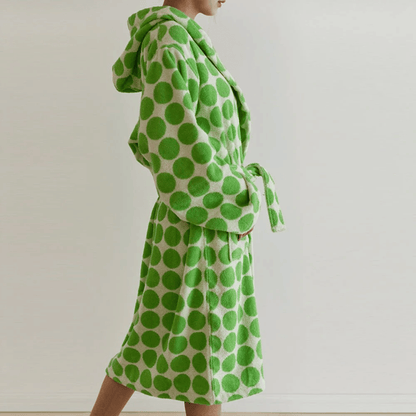 Green polka dot robe on a plain background