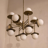 Modern chandelier with white spherical lights on a neutral background