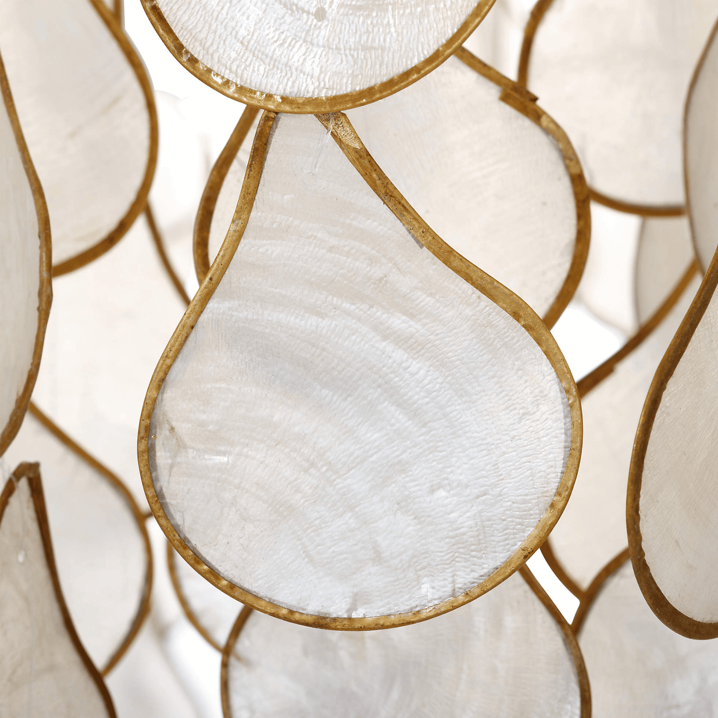Close-up of decorative glass panels with gold frames and white centers.