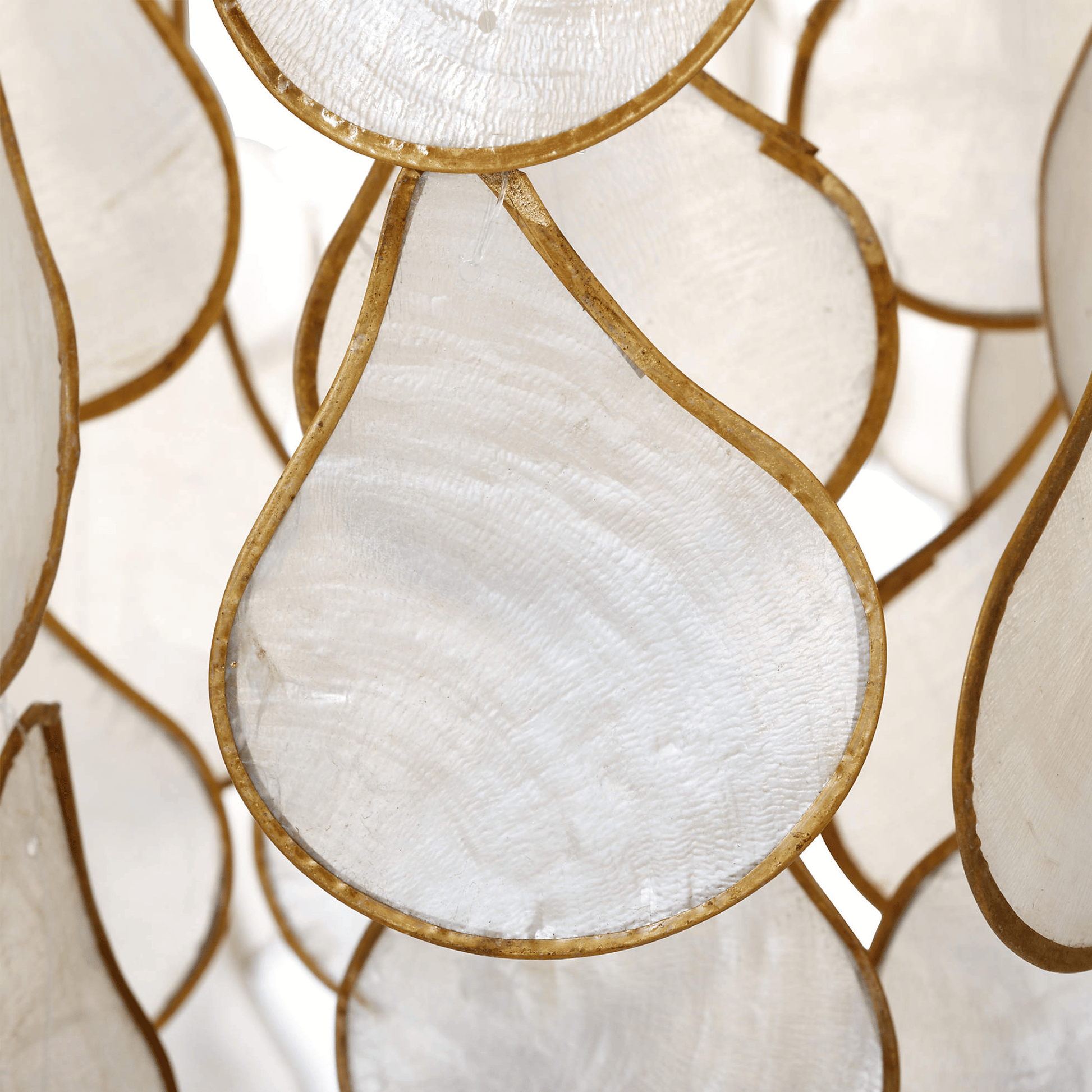 Close-up of decorative glass panels with gold frames and white centers.