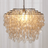Decorative chandelier with shell-like design on a white background