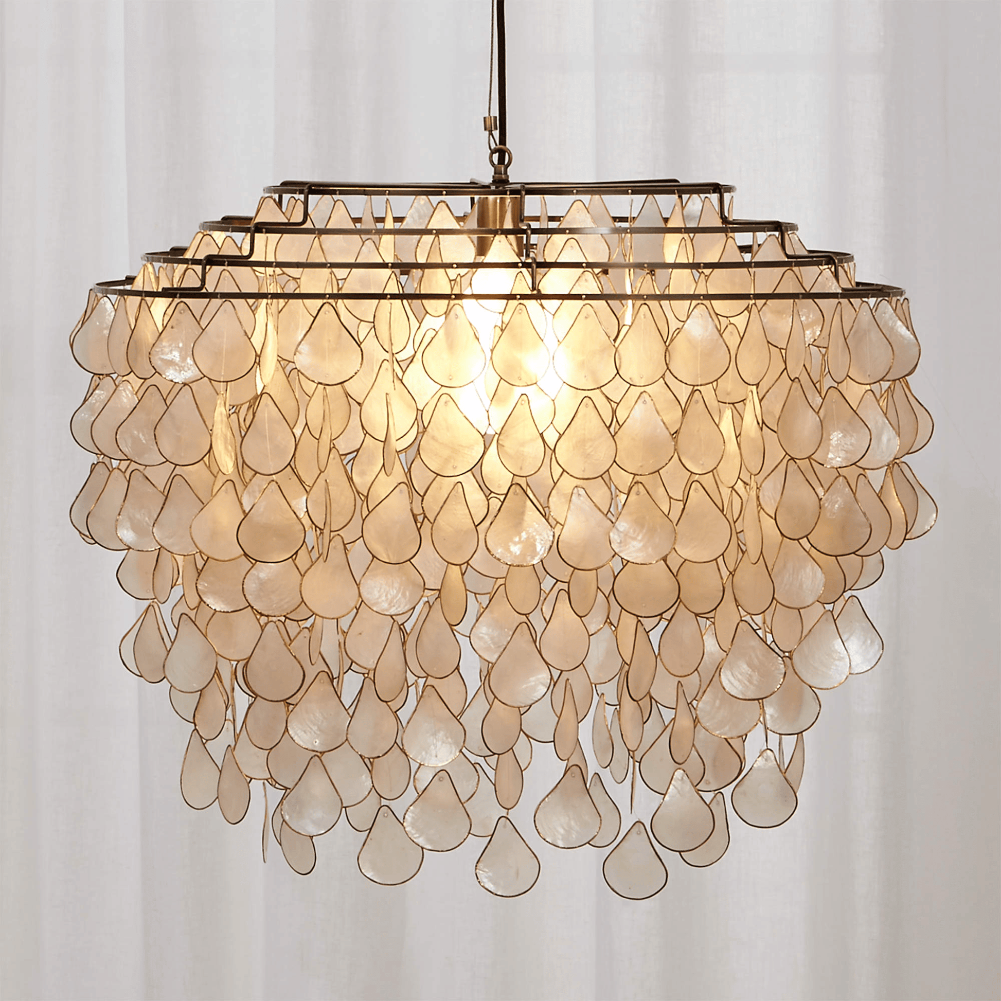 Decorative chandelier with shell-like design on a white background