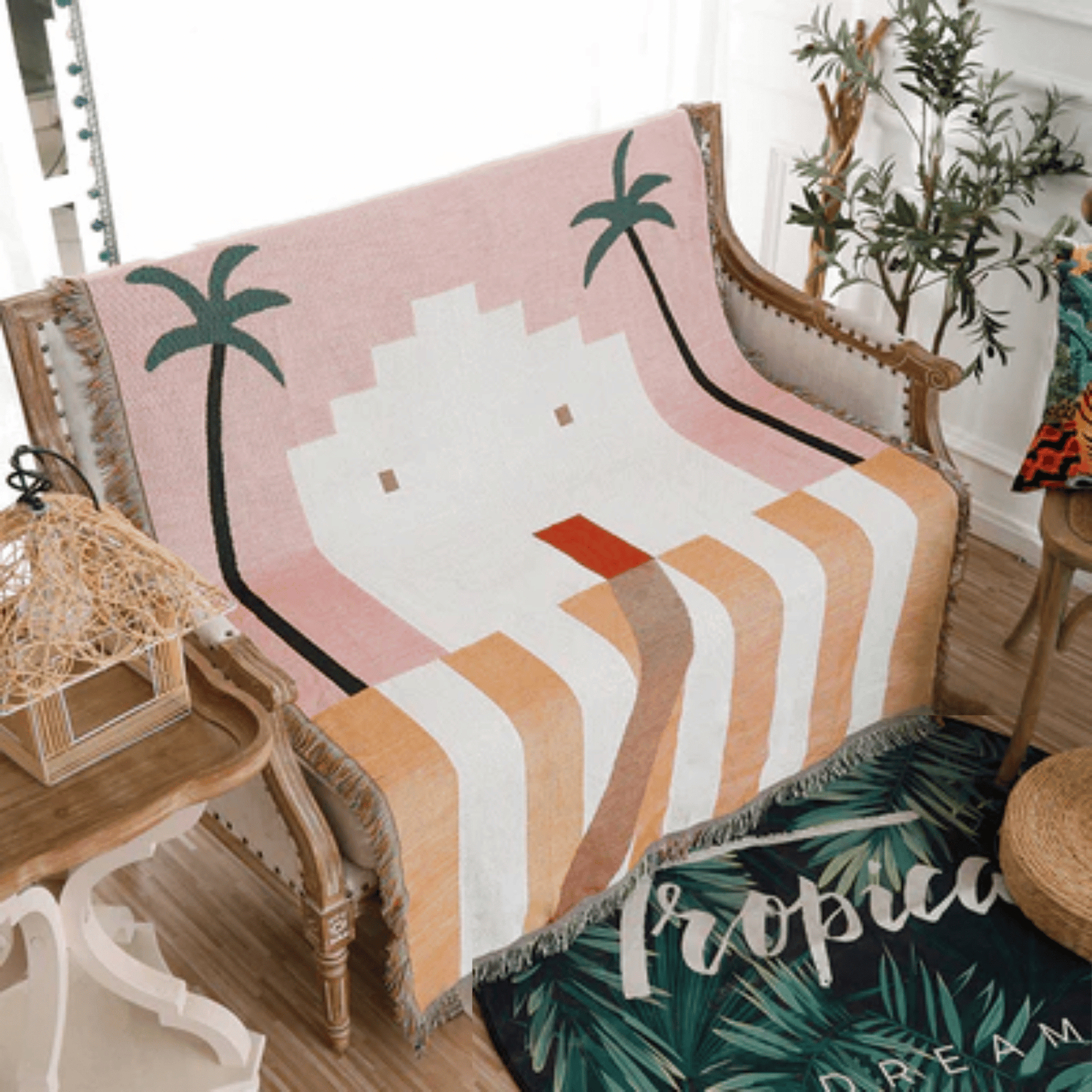 Decorative blanket with palm tree design on a chair in a room with plants.