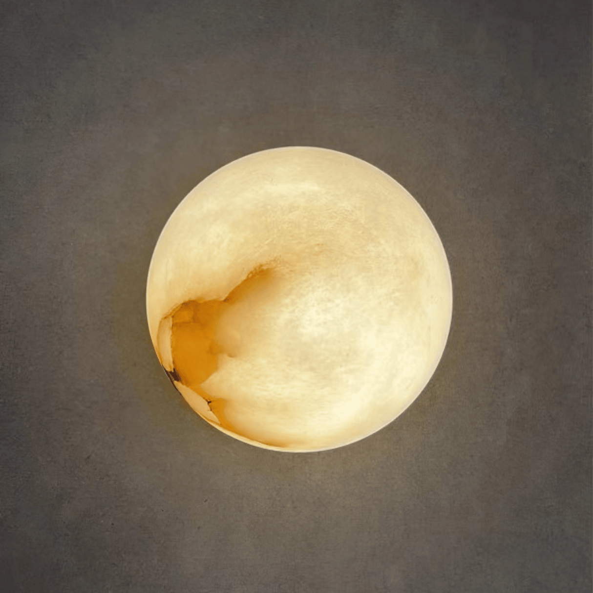 Round light fixture on a gray wall