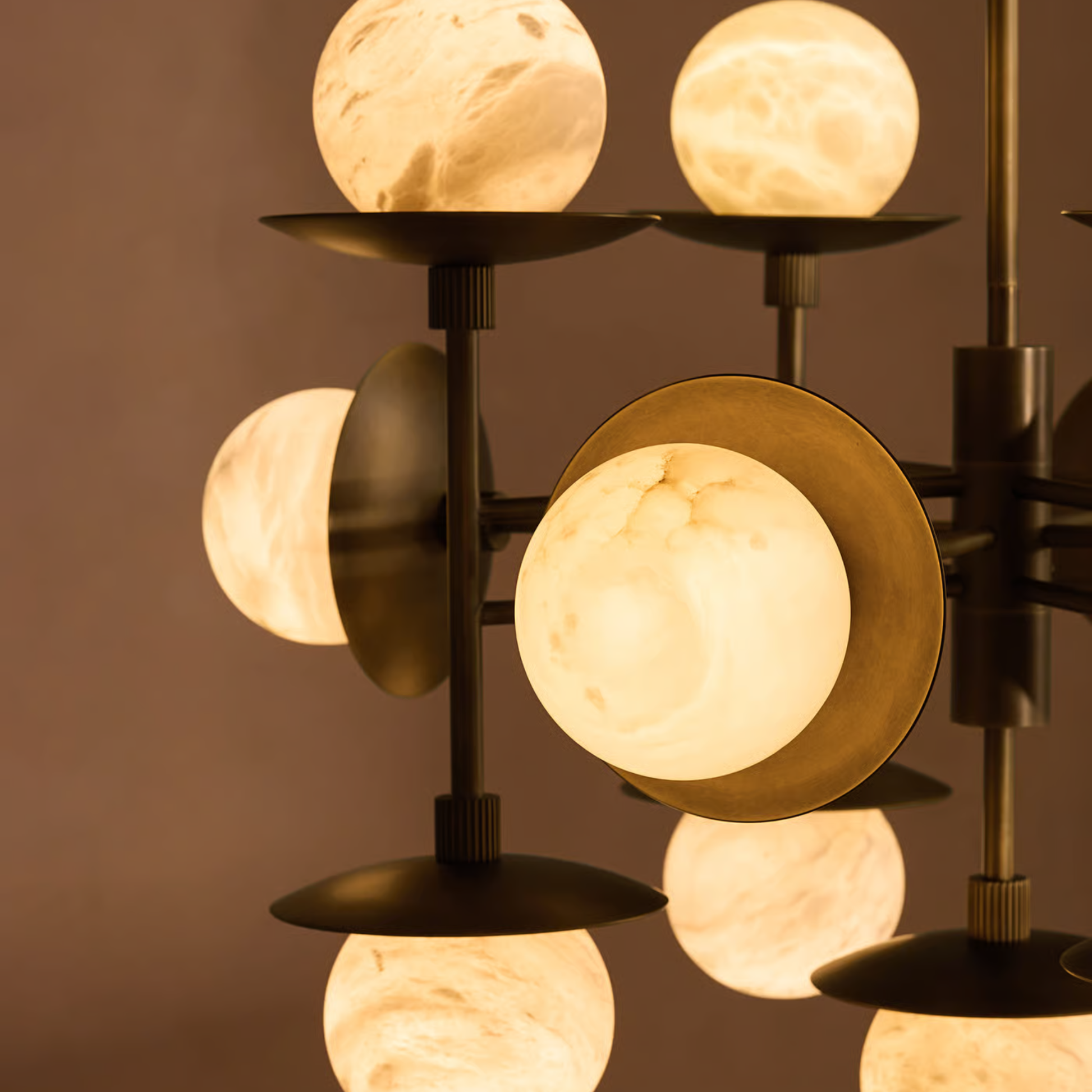 Modern chandelier with spherical lights on a brown background