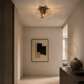 Modern interior with a ceiling light fixture, abstract art, and decorative vase.